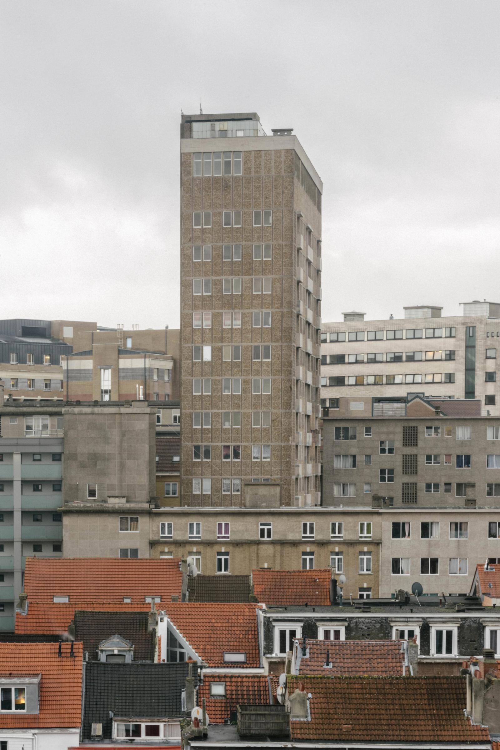 Rooftop city view toward a tall concrete tower
