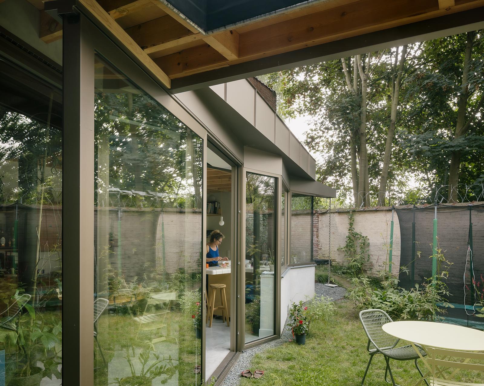 Garden view of the glass extension beneath its angled roof