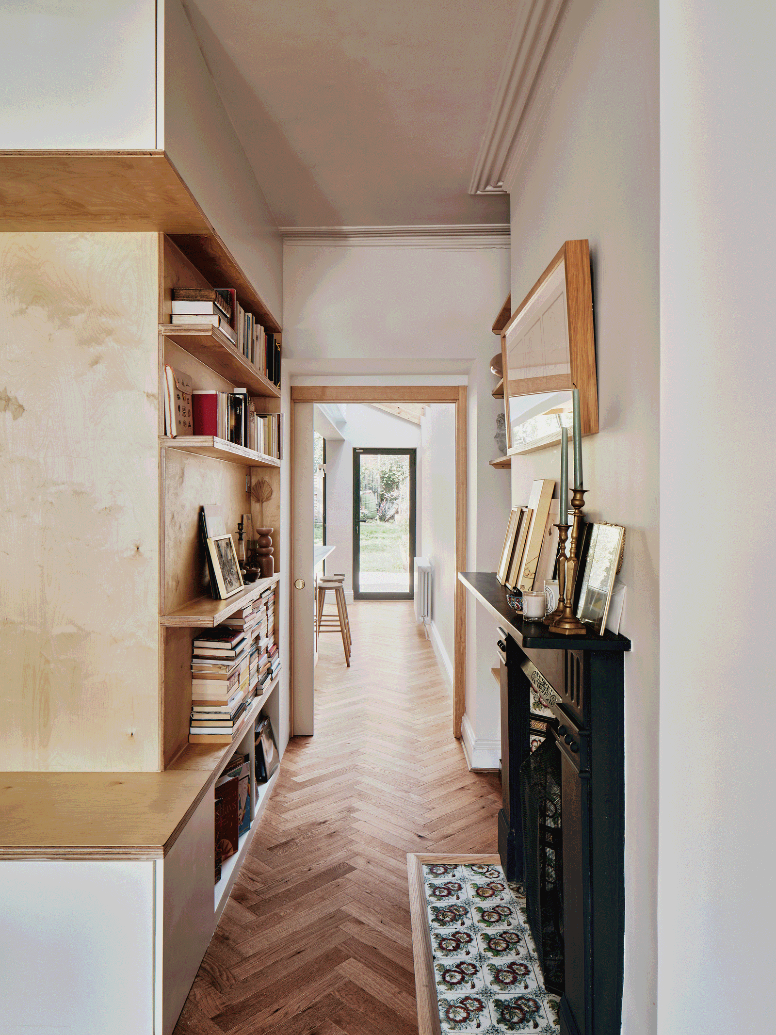 Galley kitchen and timber cabinetry beside the retained fireplace