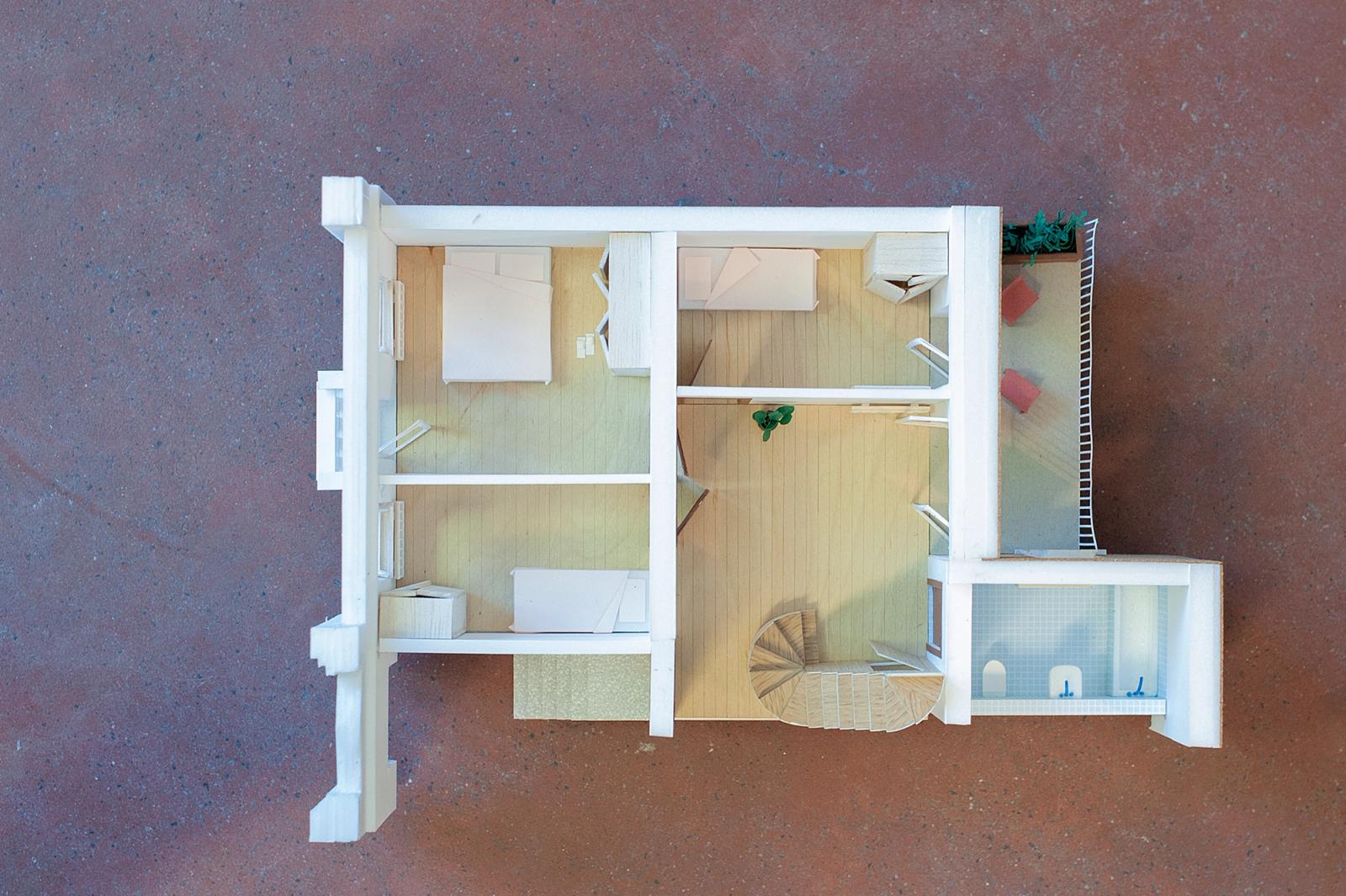Top view of a furnished apartment model with curved exterior wall