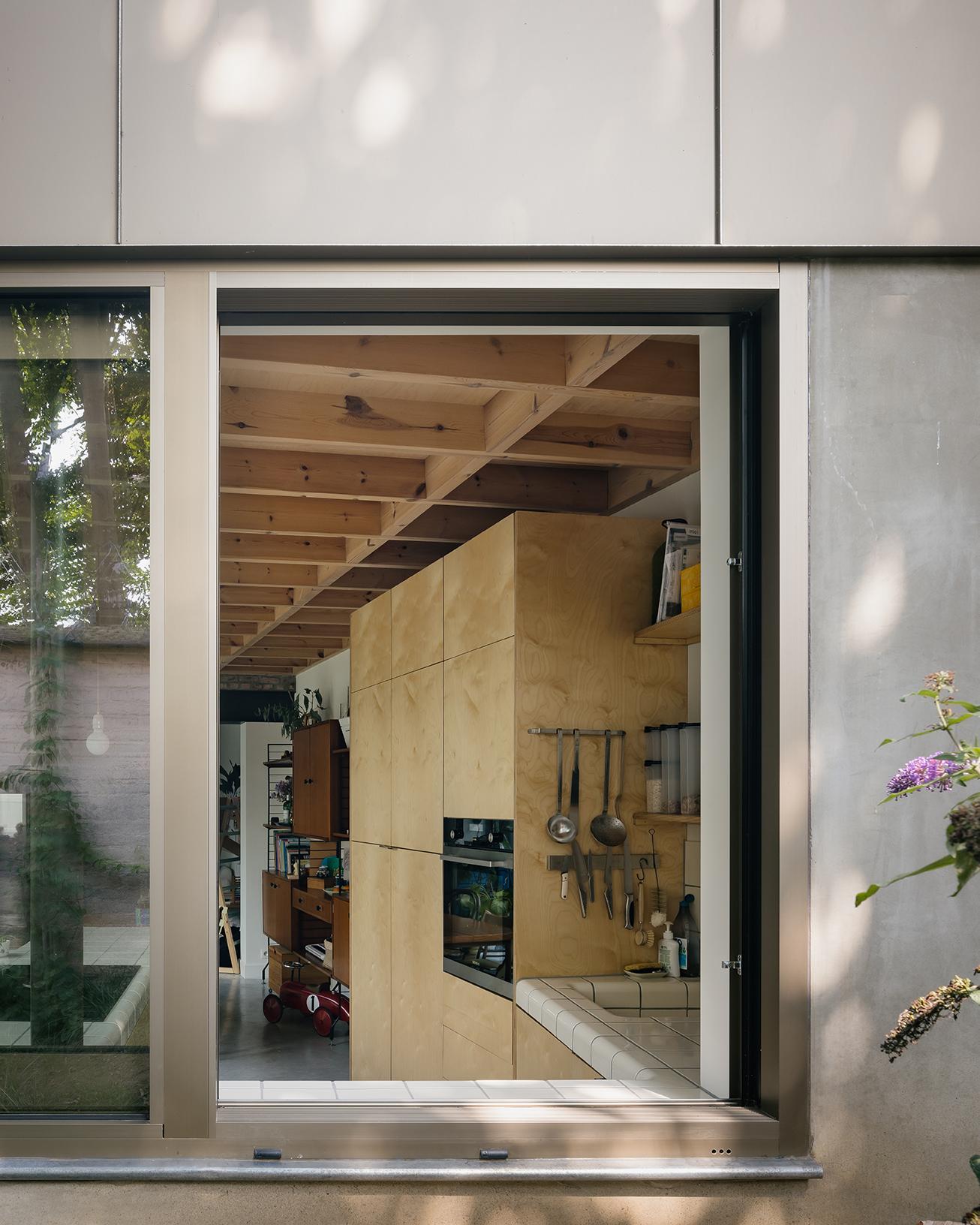 Garden doorway revealing timber cabinetry inside the extension