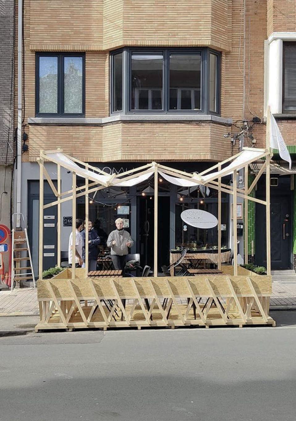 Front view of the parklet installed against an urban building
