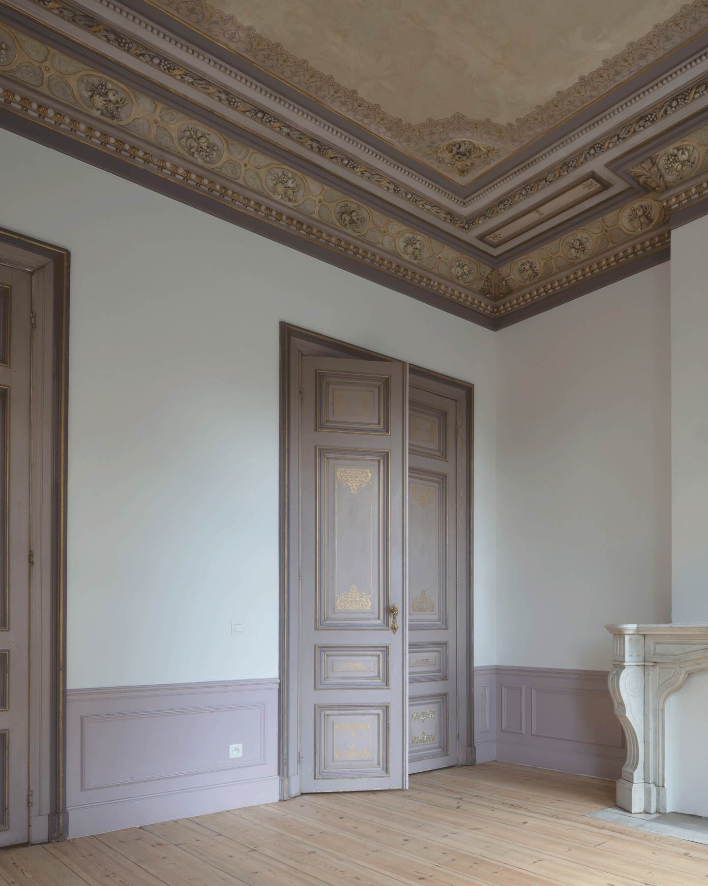 Restored historic room with timber doors and decorated ceiling