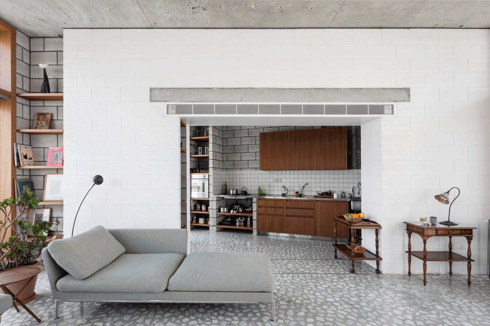 White block partition framing the timber kitchen and living room