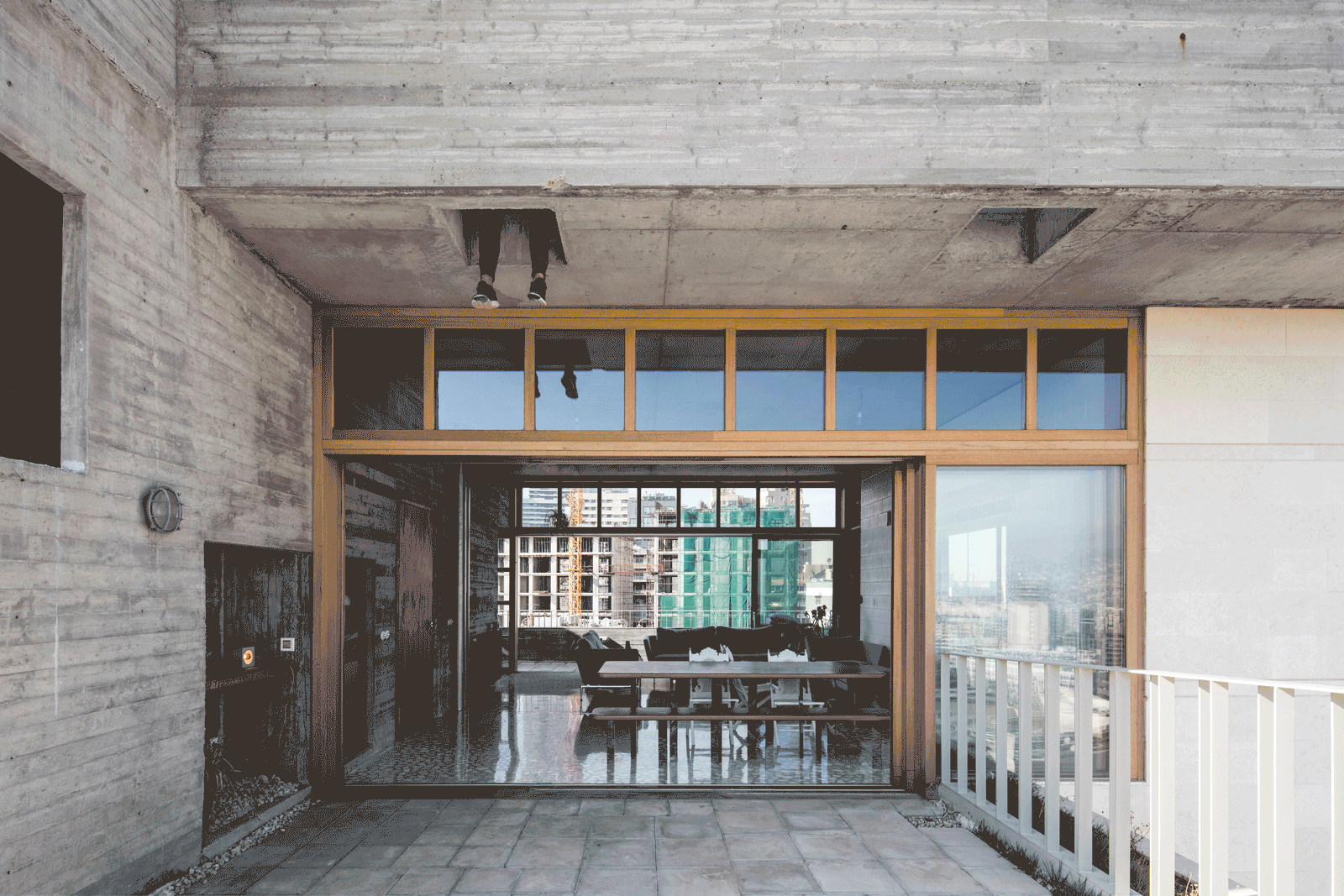 Timber-framed glazing connecting the interior to the roof terrace