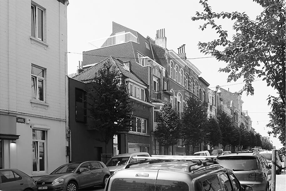 Black-and-white street view of the dark façade extension