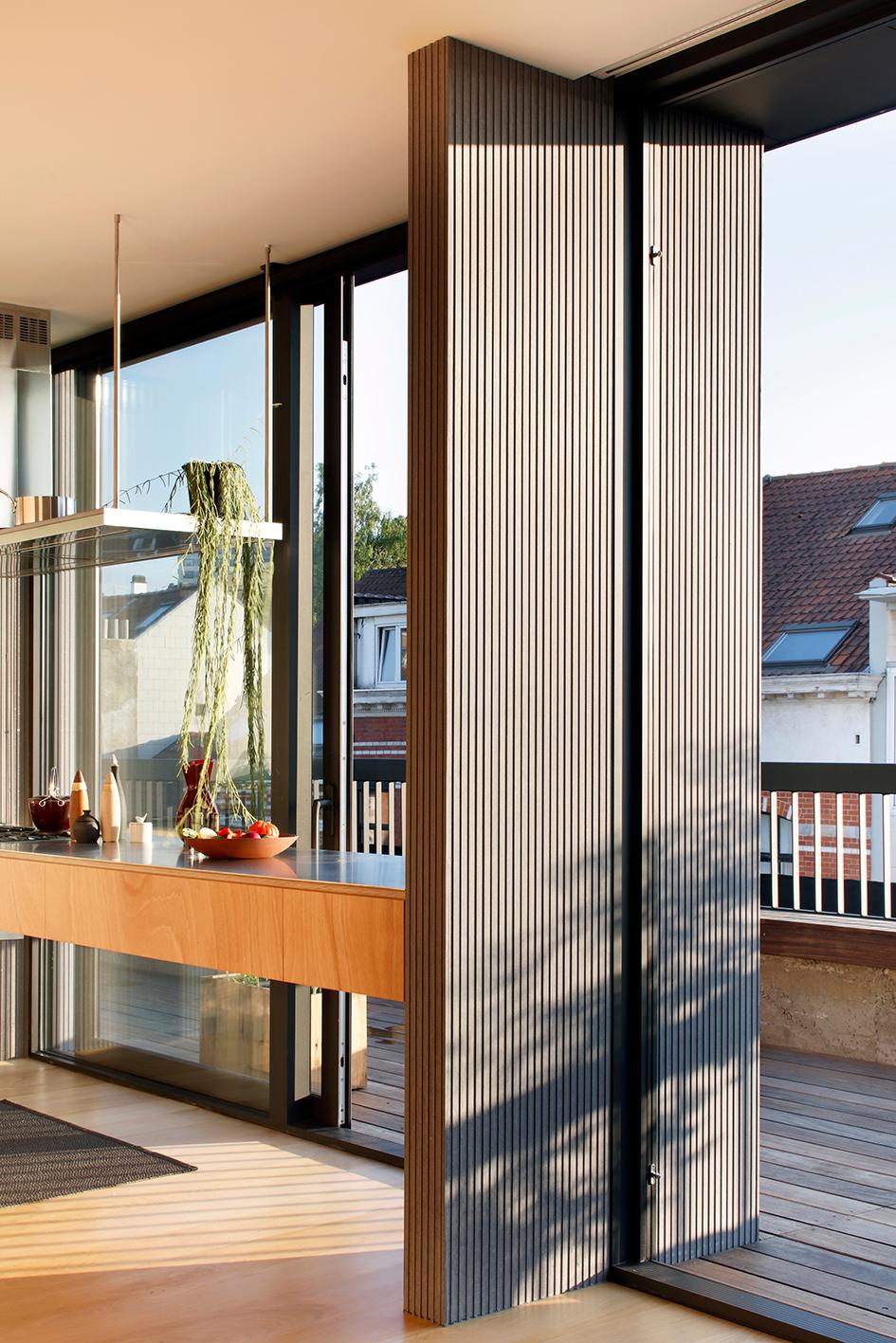 Folding glass wall opened between the kitchen and roof terrace