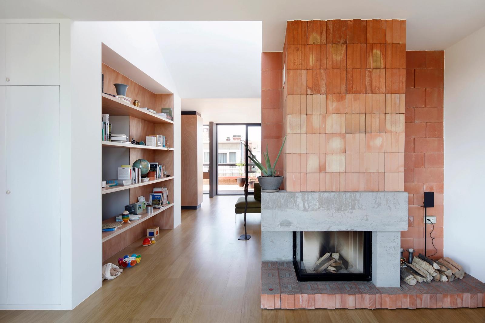Living room organized around a broad brick and concrete fireplace