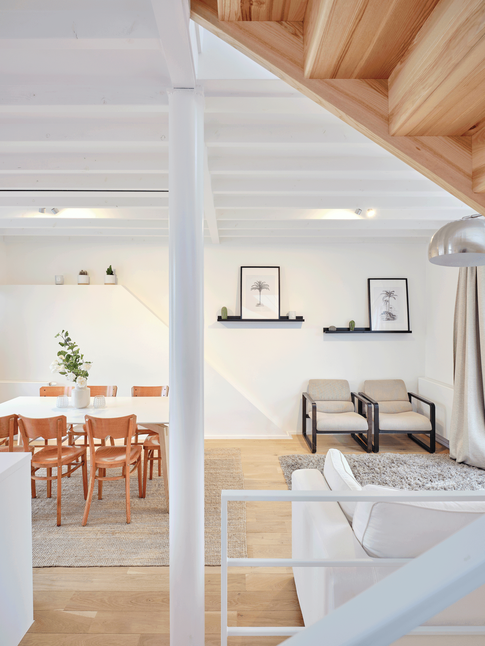 Open living and dining rooms beneath a timber mezzanine