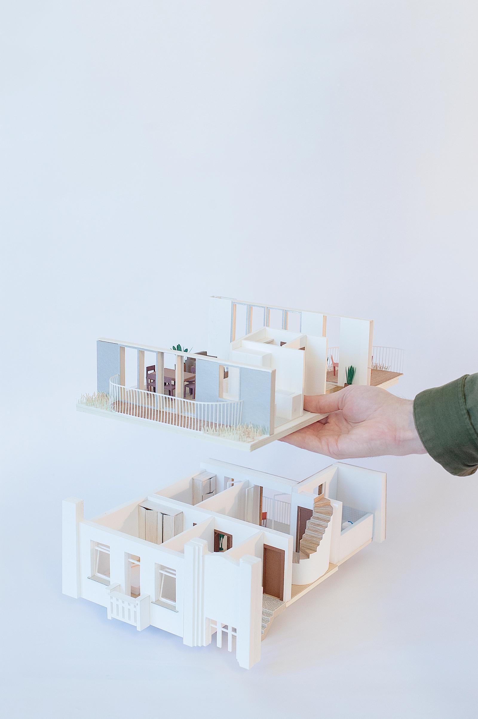 Two small white physical models of apartment interiors