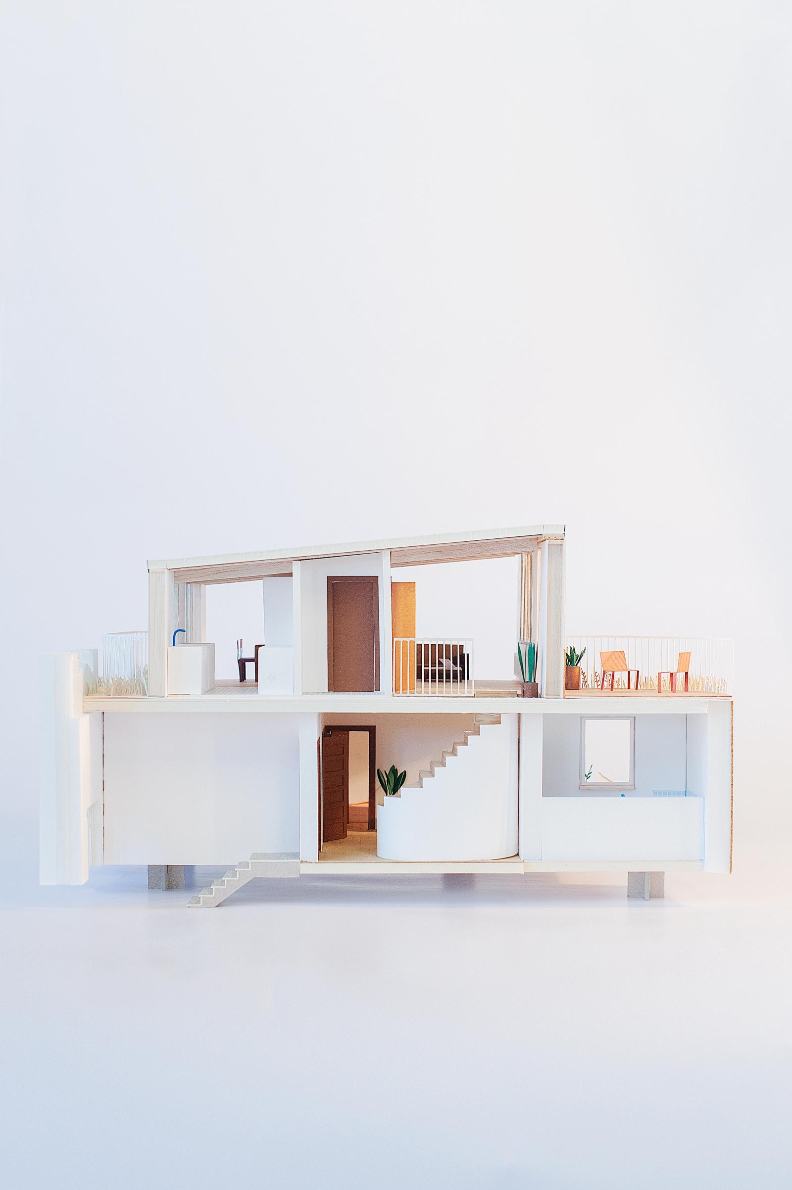 Sectional apartment model showing two levels and a recessed terrace