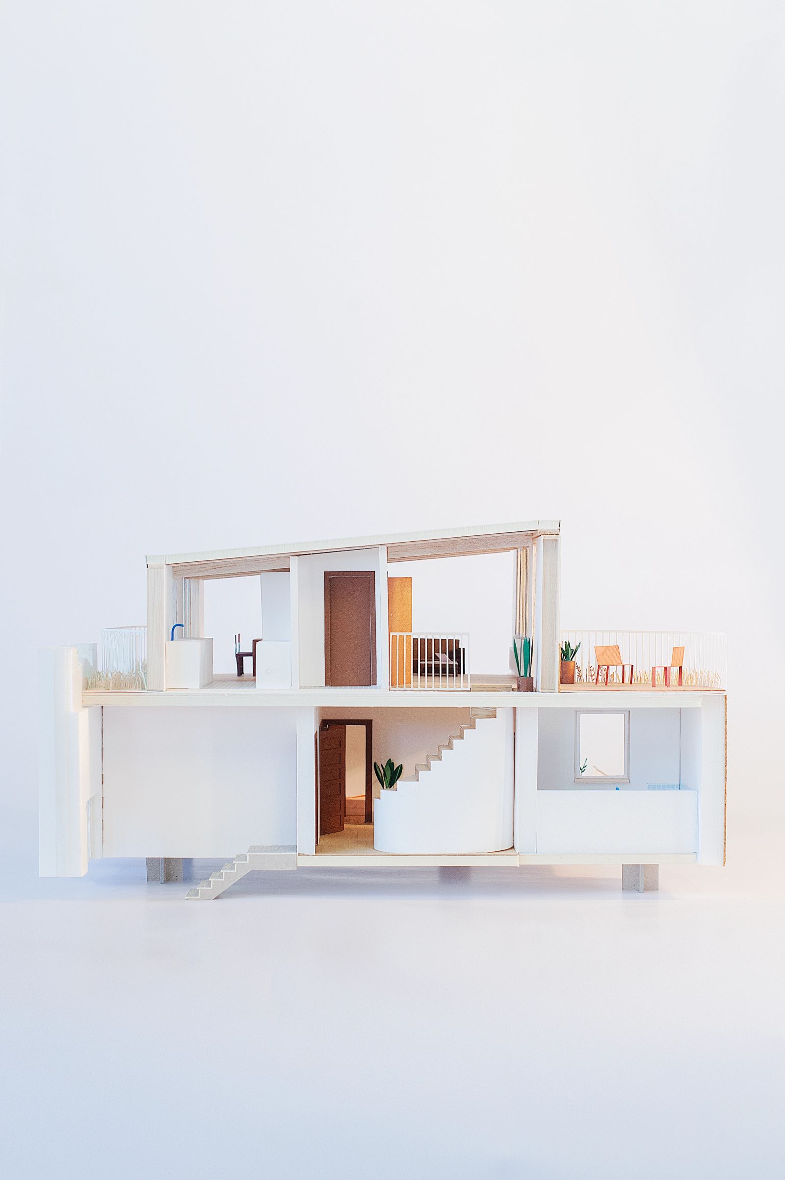 Sectional apartment model showing two levels and a recessed terrace