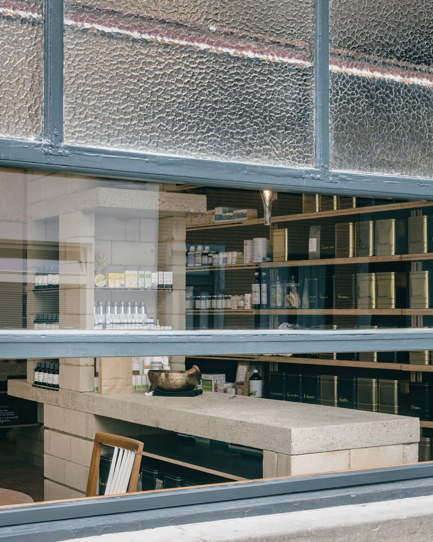 Shop interior seen through a mesh-covered street window