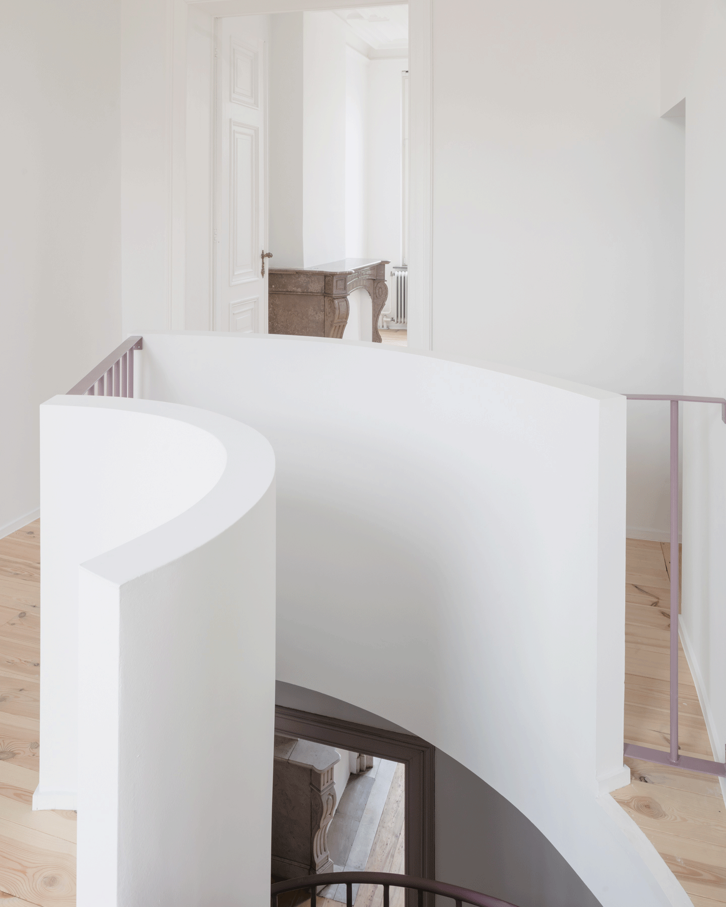 Curving white stair and balustrade in the restored interior