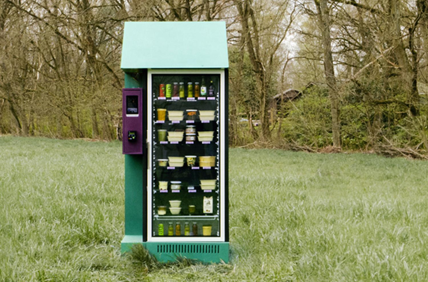 Front view of the green kiosk filled with jars and produce