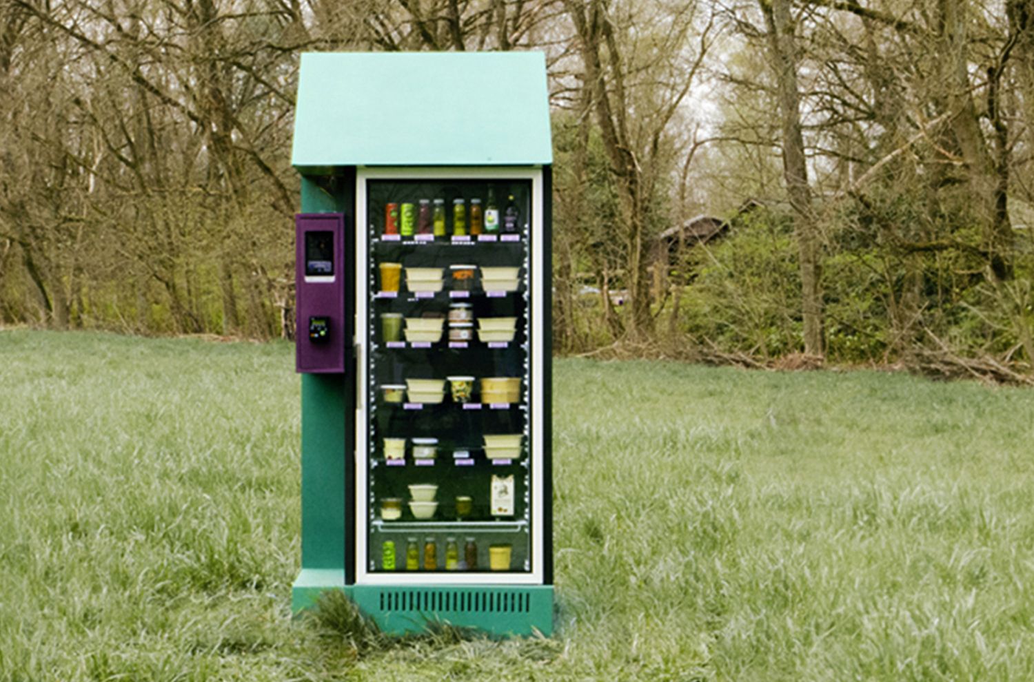Front view of the green kiosk filled with jars and produce