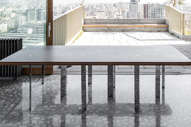 Long rounded table standing on a terrazzo terrace