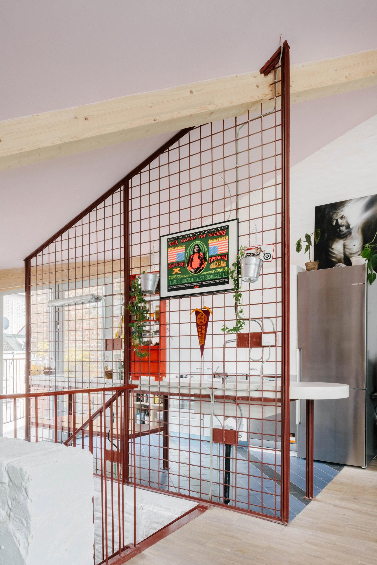 Red grid partition and curved white counter beside the stair