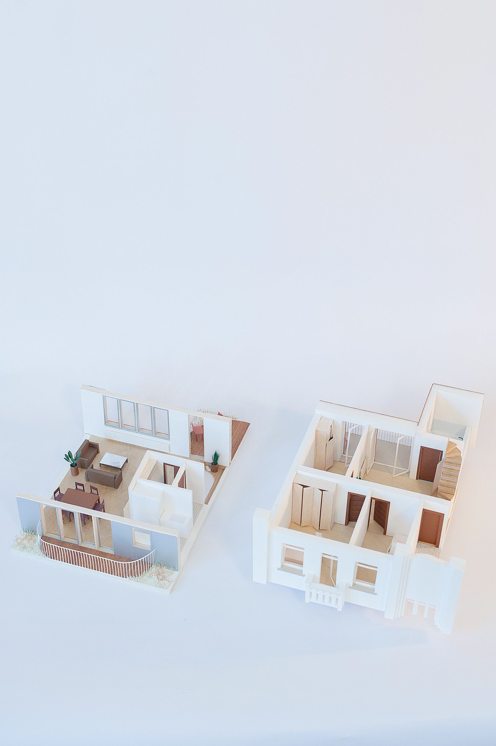 Pair of white apartment models showing alternative arrangements