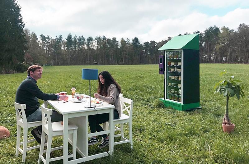 Outdoor meal beside the stocked kiosk in an open field