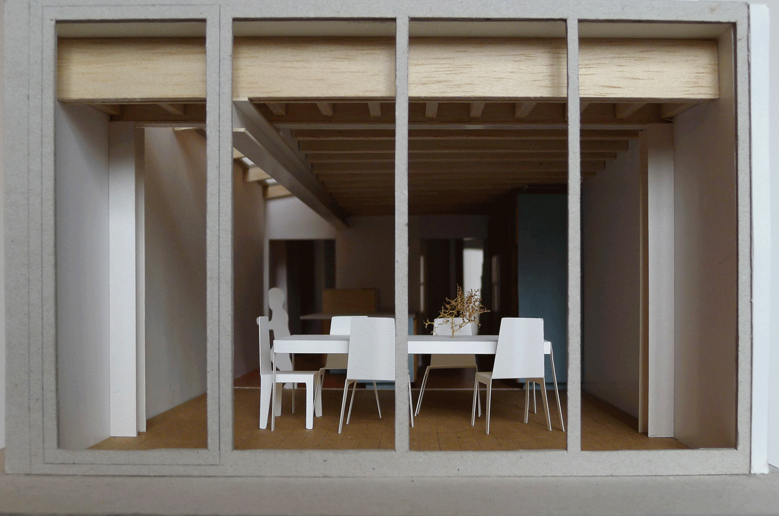 Dining room seen through a large timber-framed garden opening