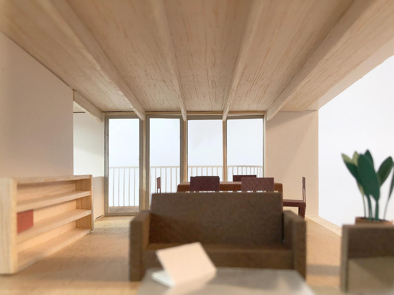 Interior model of a living room framed by a deep terrace opening
