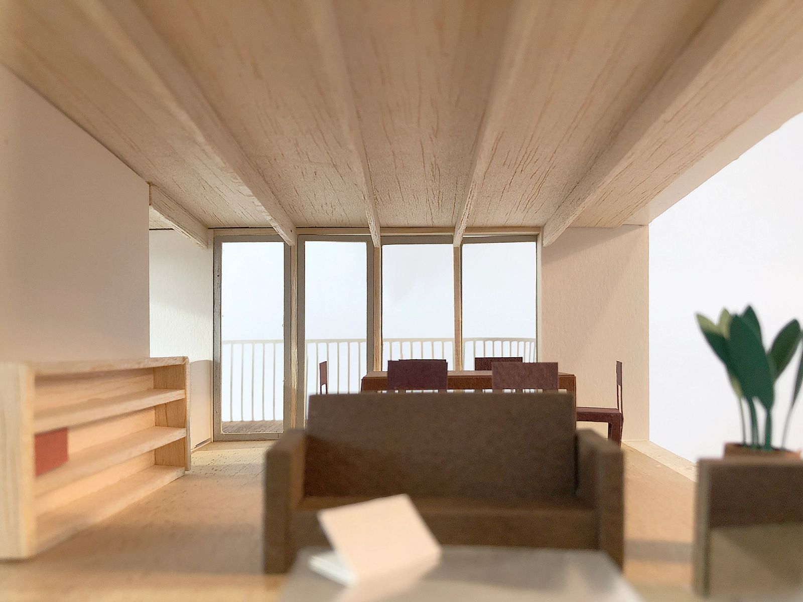 Interior model of a living room framed by a deep terrace opening