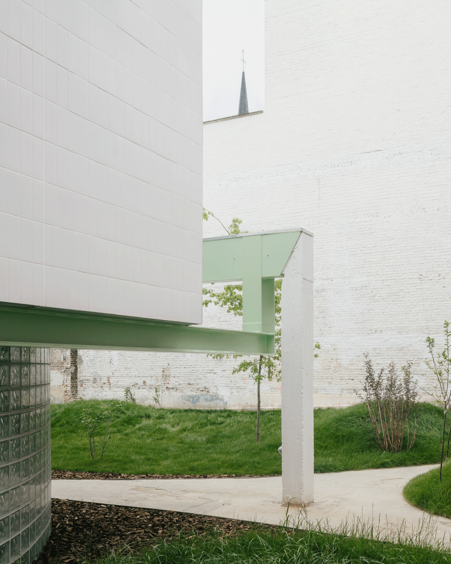Curving garden path running beneath a white overhang