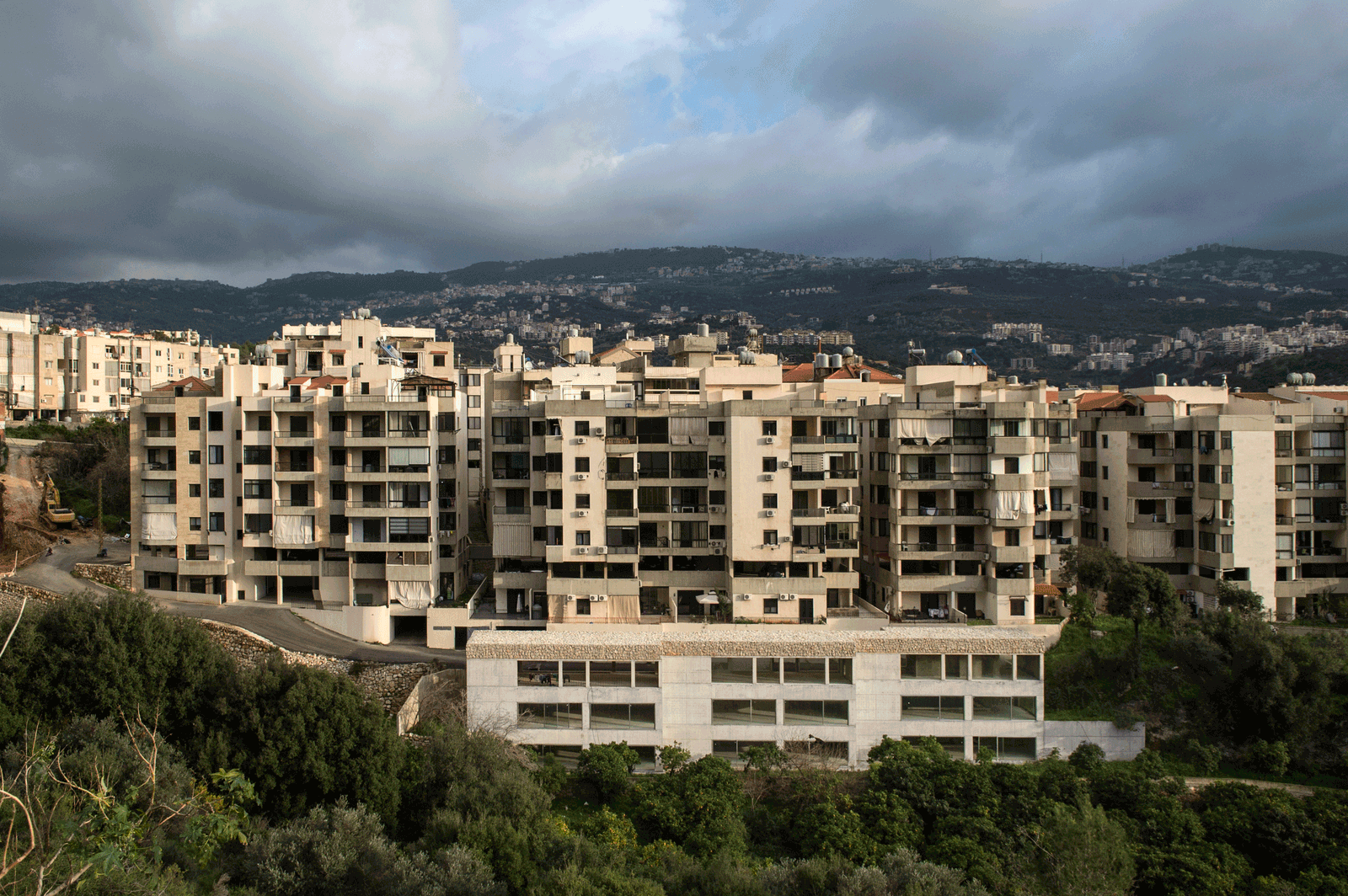 Distant view of apartment blocks against a mountainous skyline