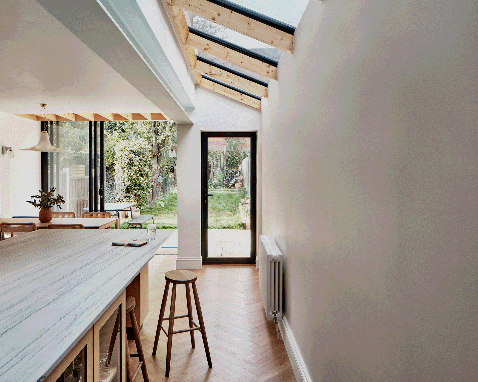 Long kitchen island aligned with a glazed garden door