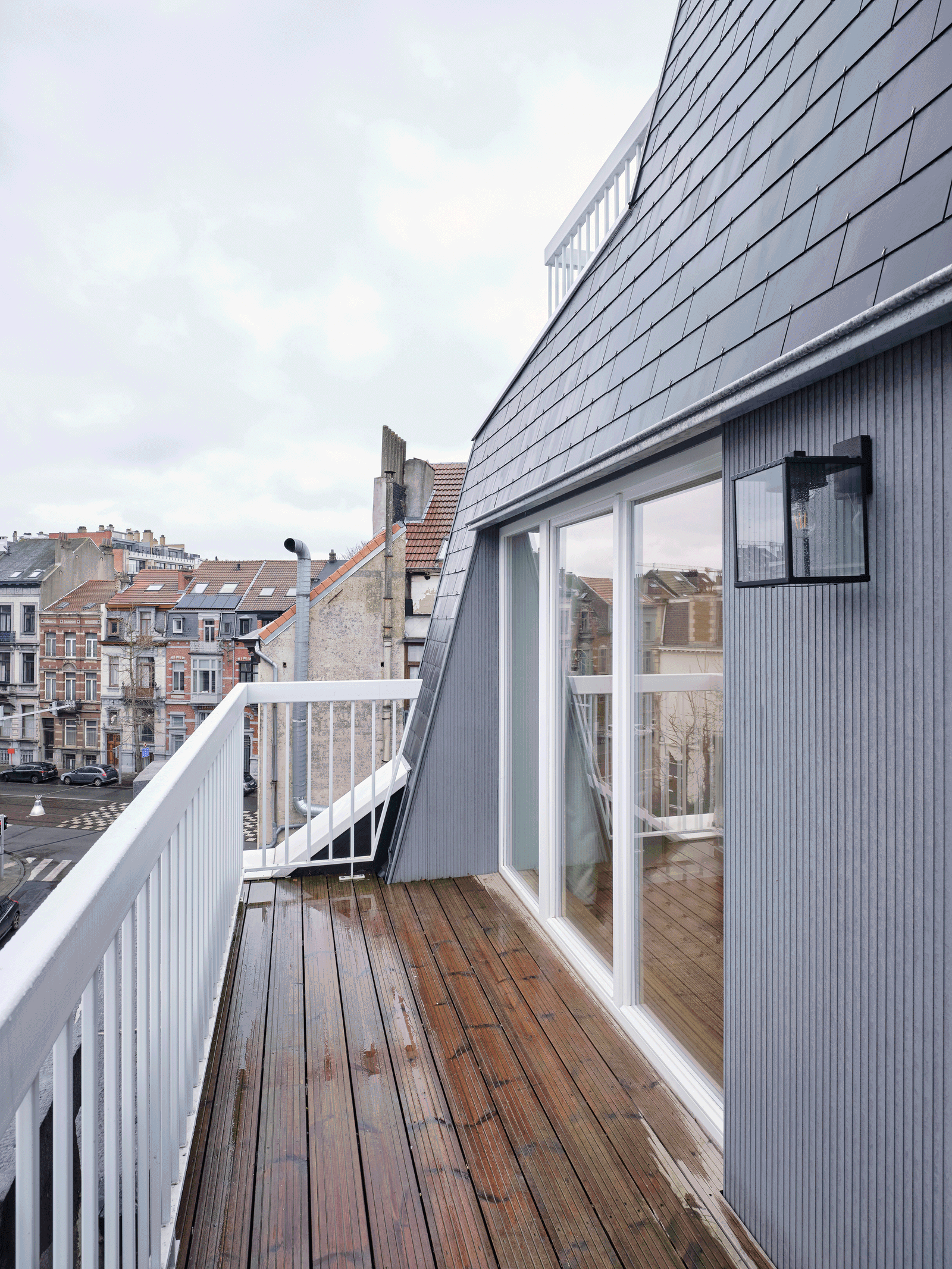 Narrow roof terrace beside the dark-clad dormer