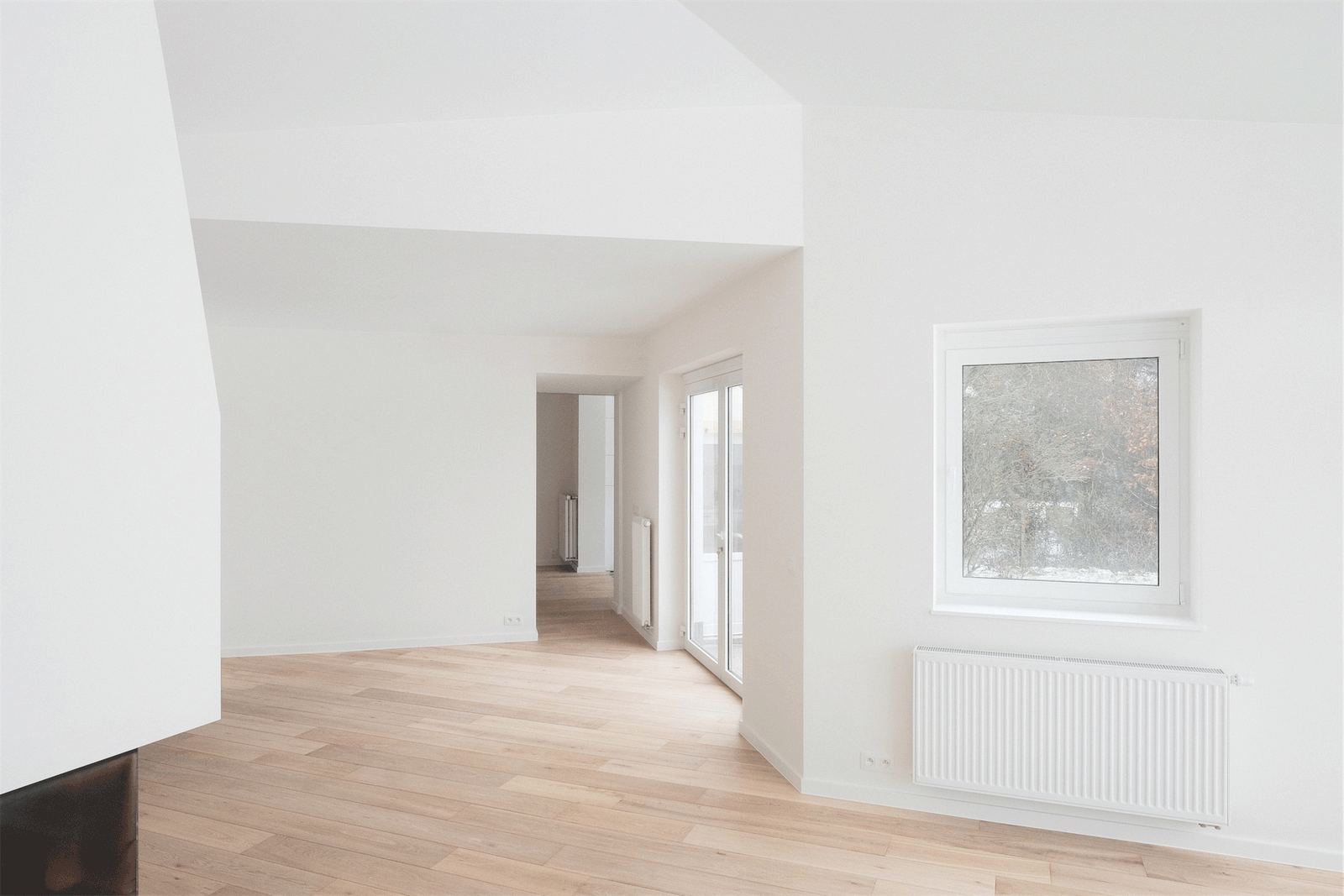 Bright living room with timber floor and a sequence of doorways