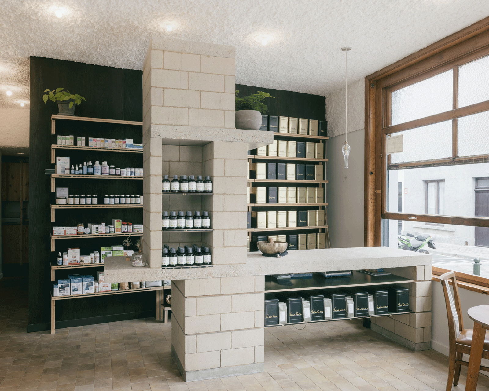 Product shelves beside a broad timber-framed street window