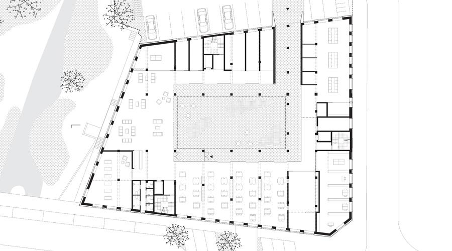 Ground-floor plan with shared spaces opening to the central court