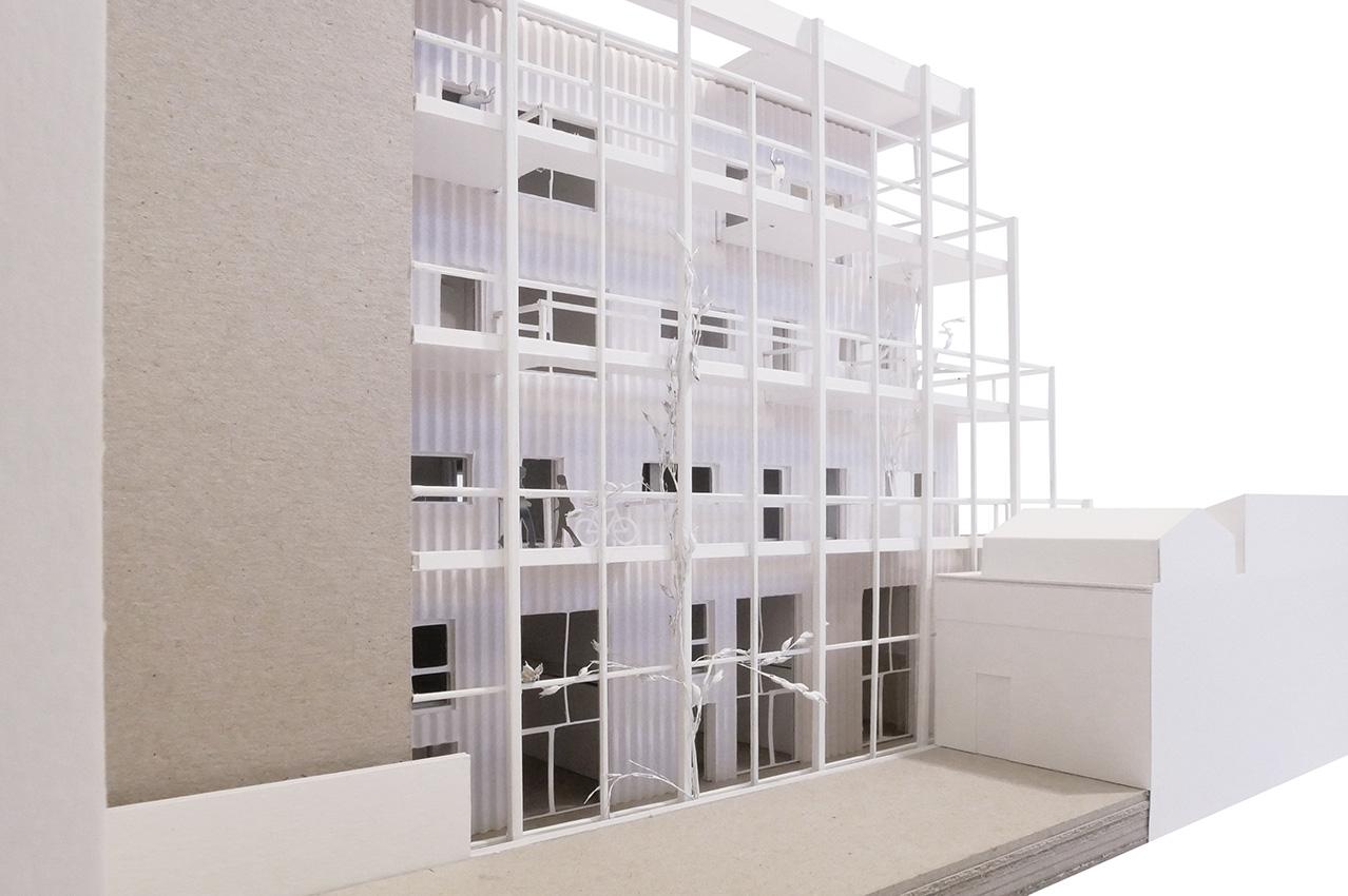 Physical model showing a white lattice added to a masonry building