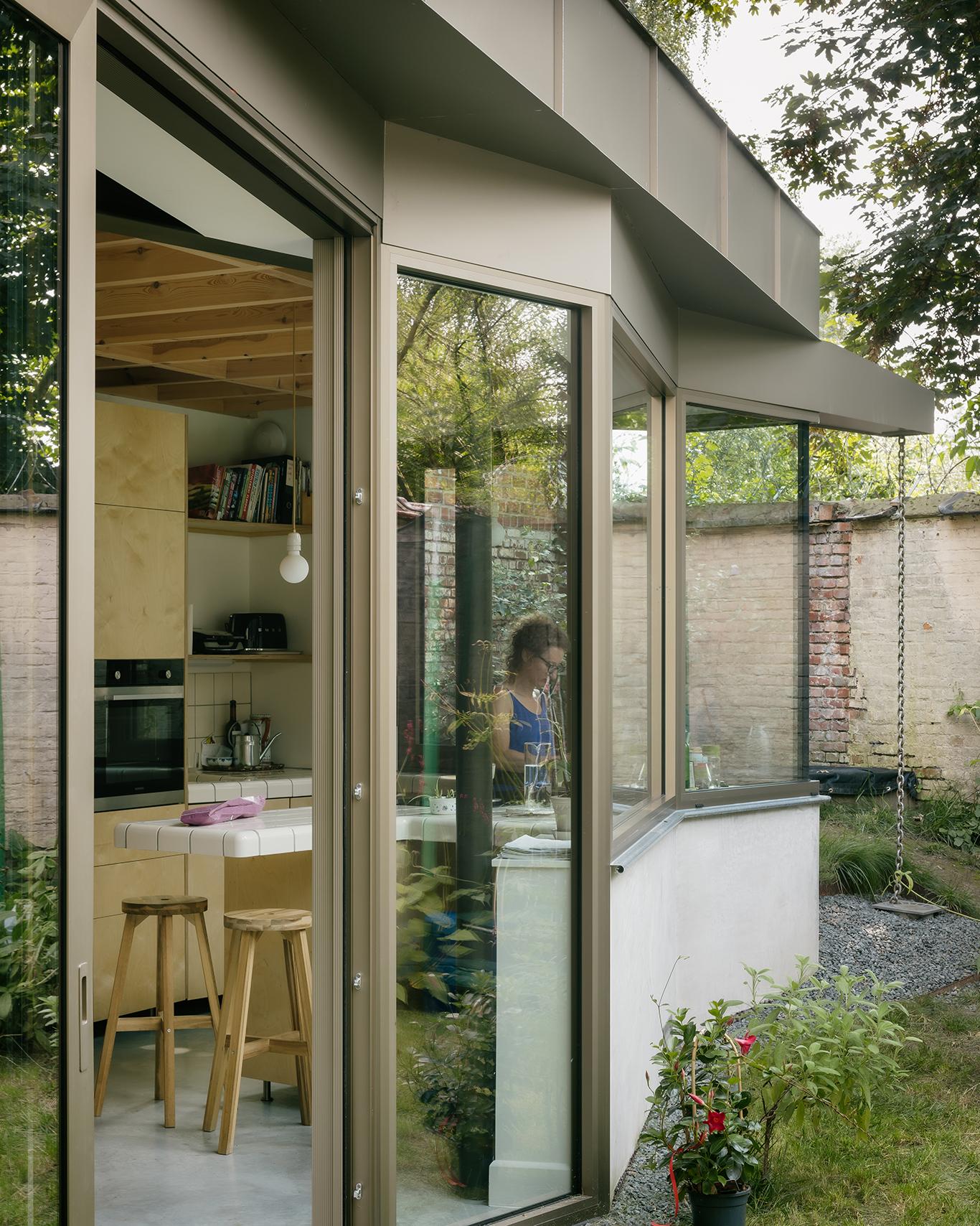 Exterior corner of the glass extension beside the original house
