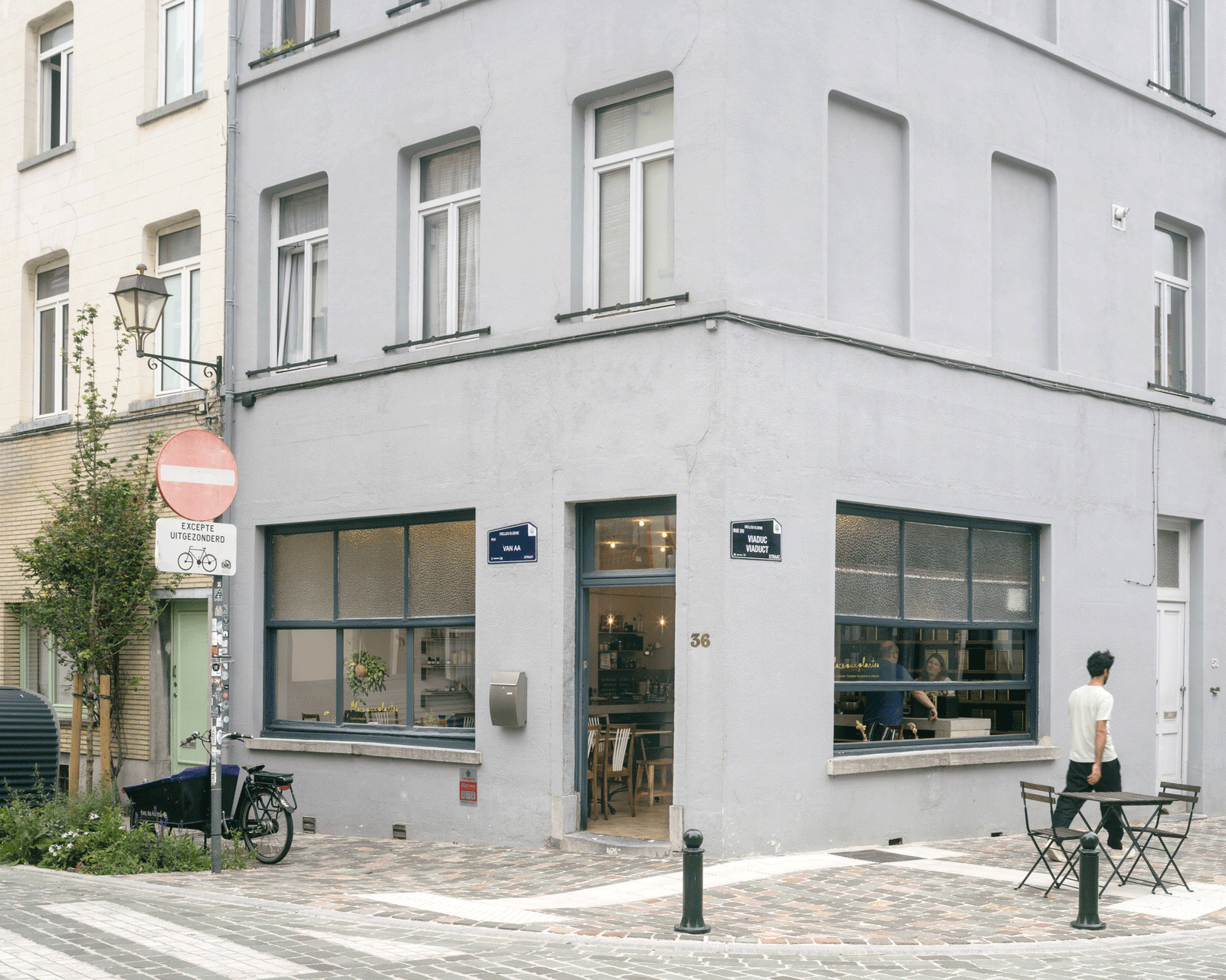 Corner storefront with broad windows opening to the pavement