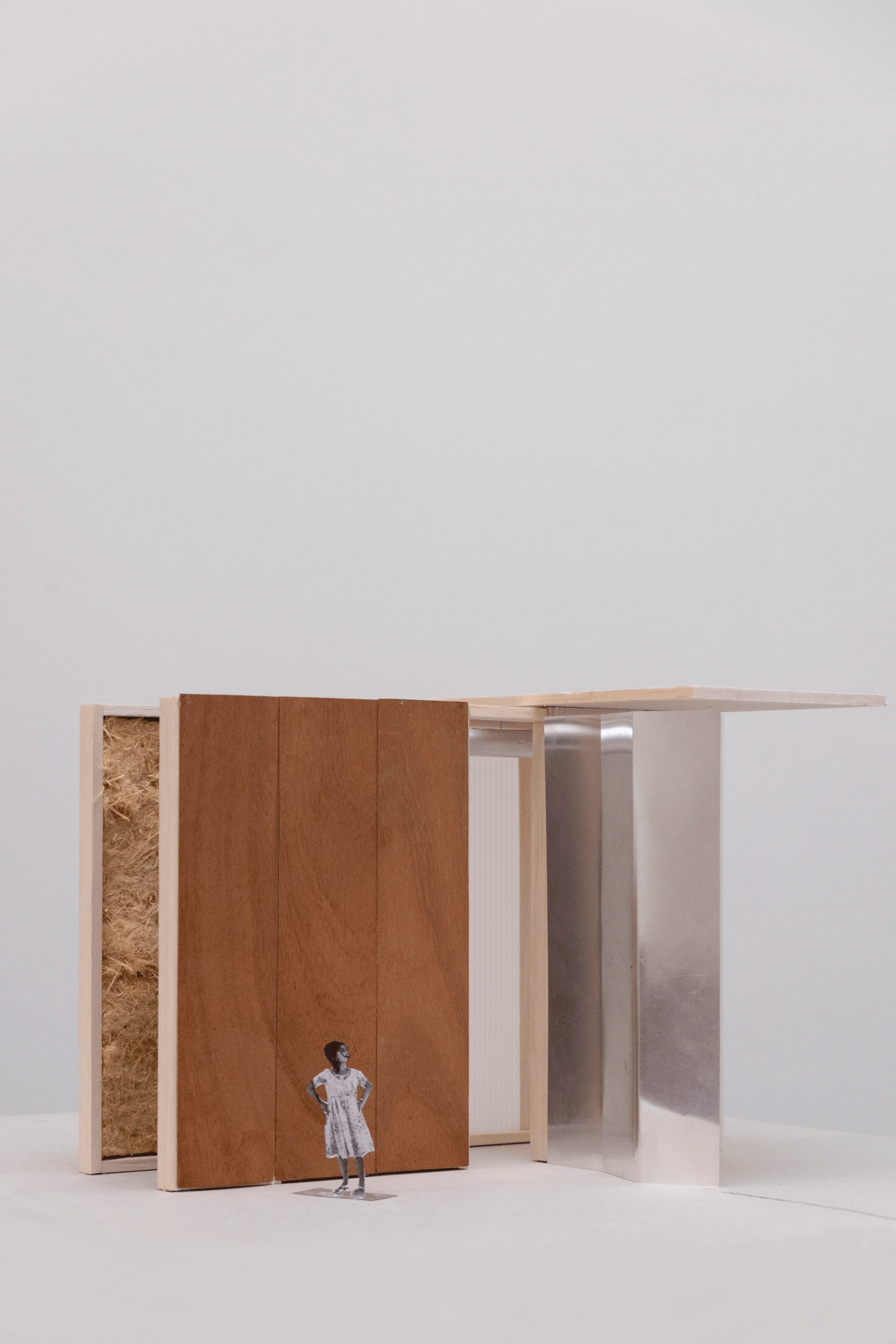 Physical model of a compact timber-lined retail threshold