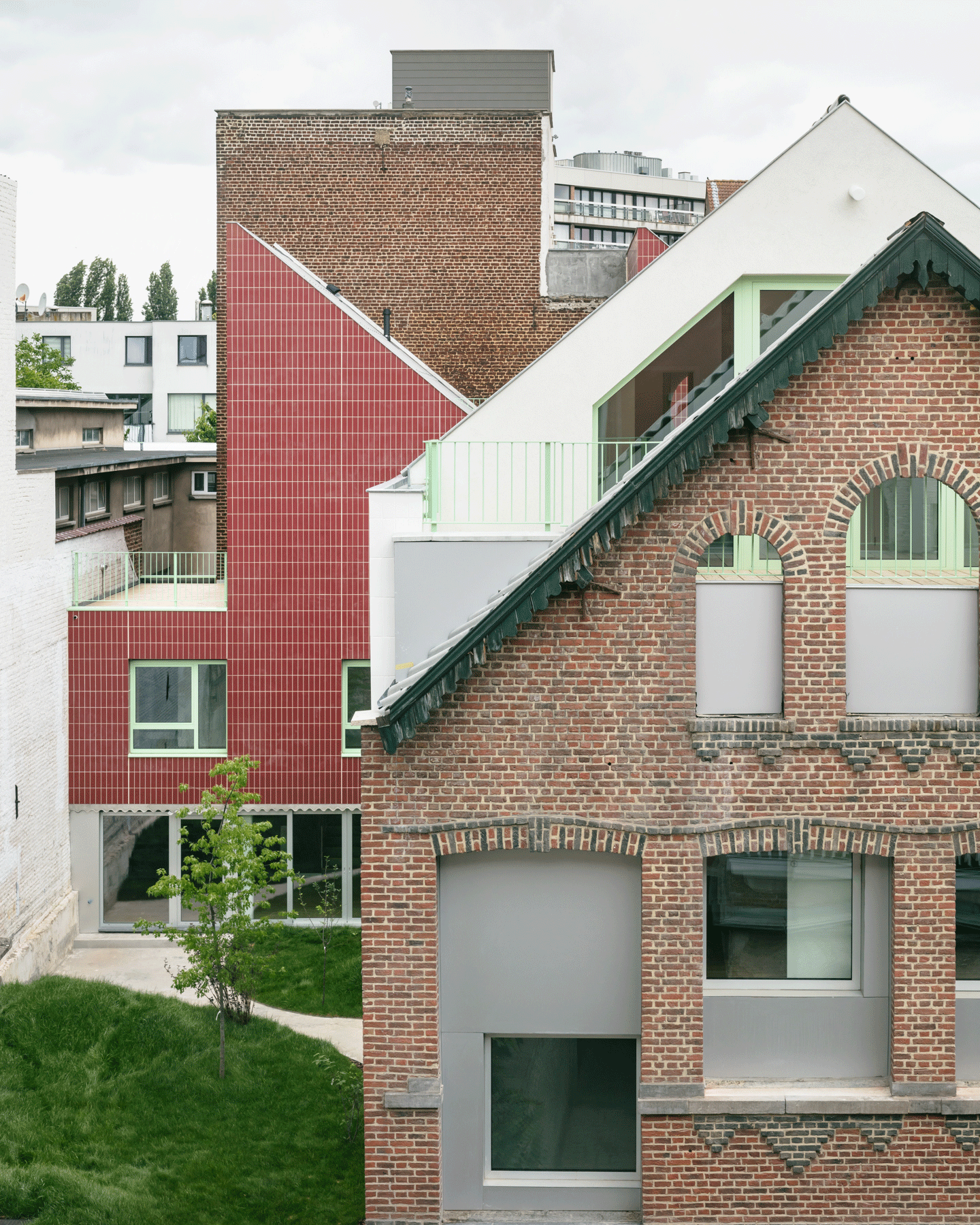 Retained brick house in front of the red and white additions