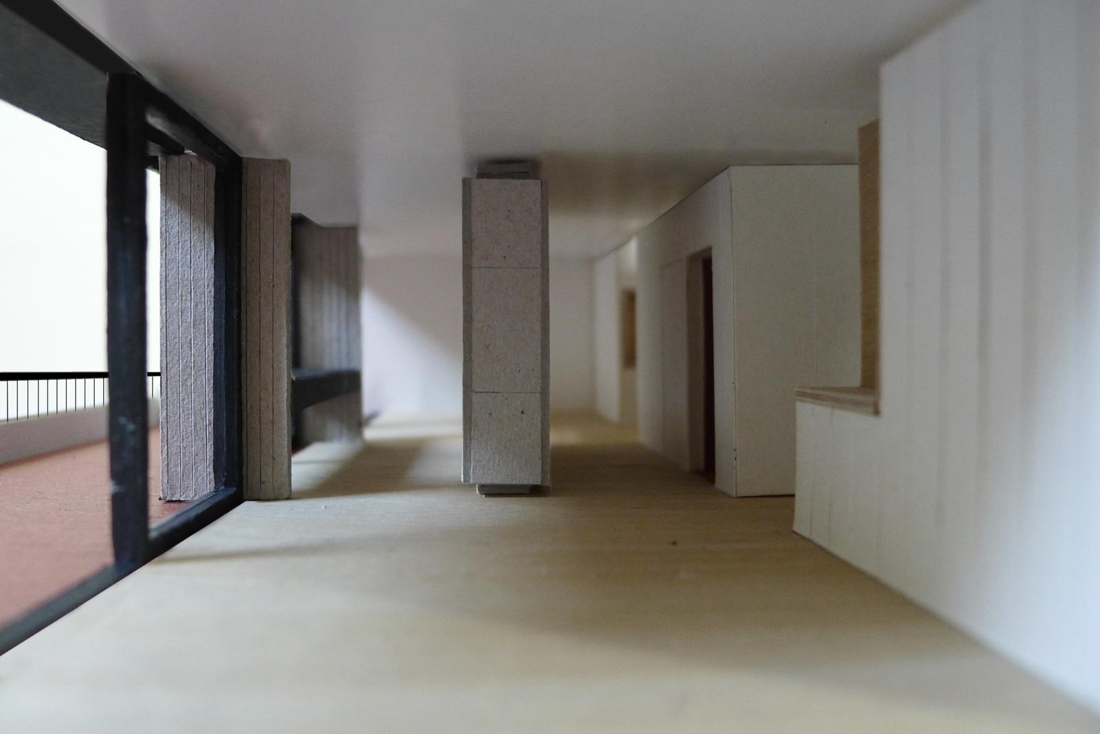 Unfinished open apartment with long windows and white partitions