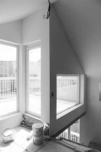 Black-and-white view through an angular stairwell window