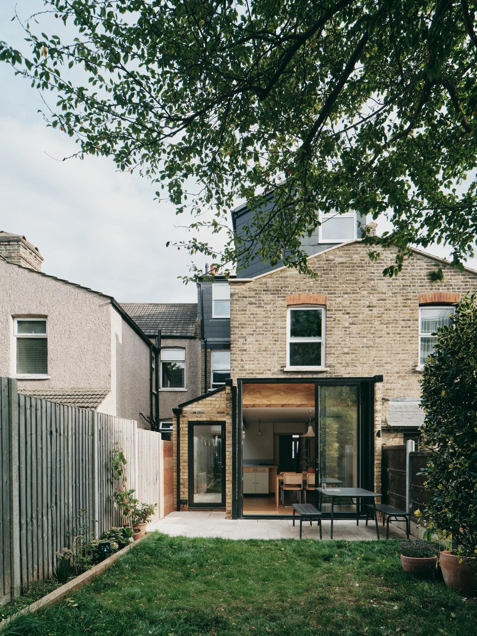 Rear garden view of the low extension to the brick house
