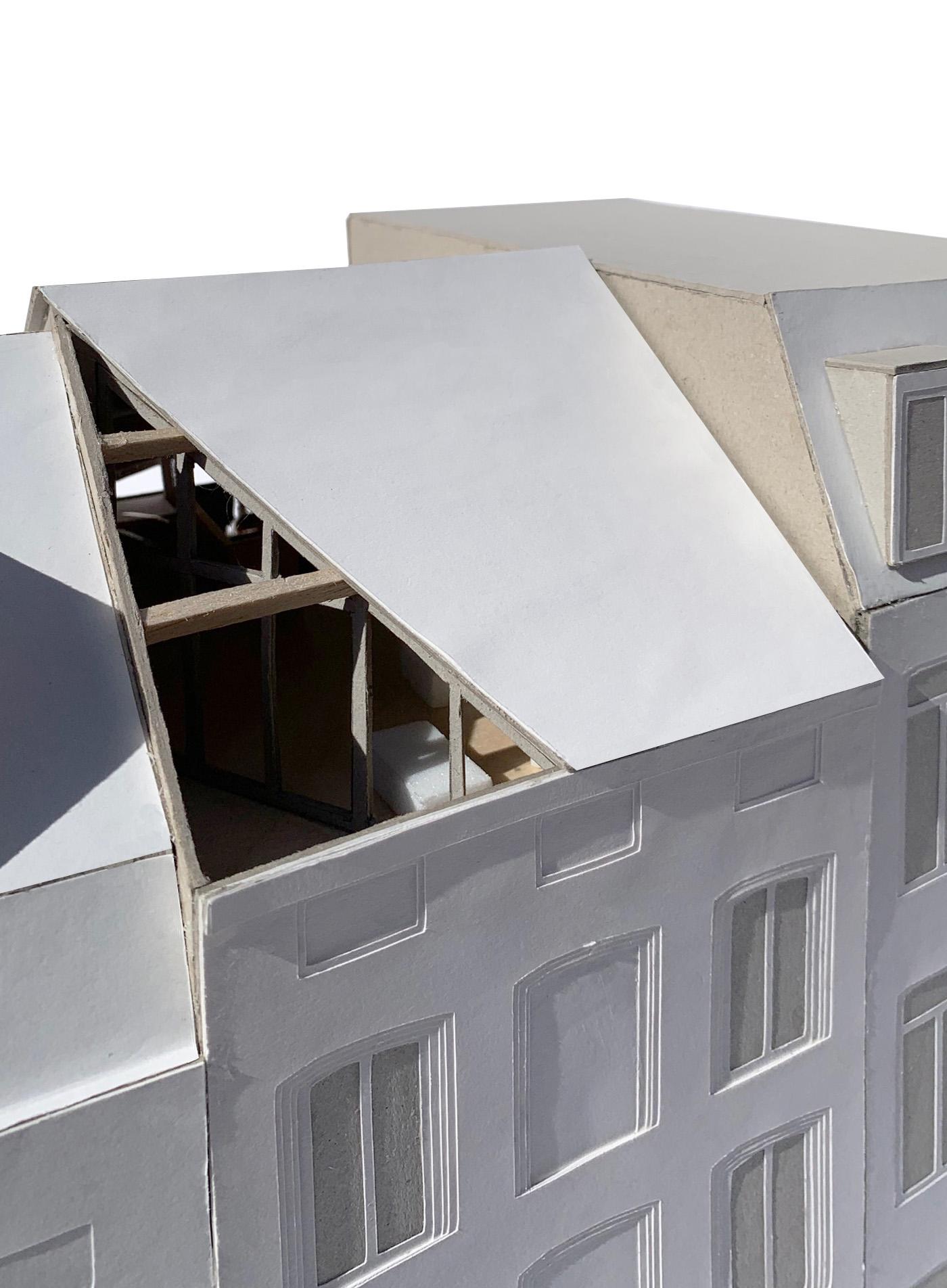 White exterior model with an angular roof cut revealing timber structure