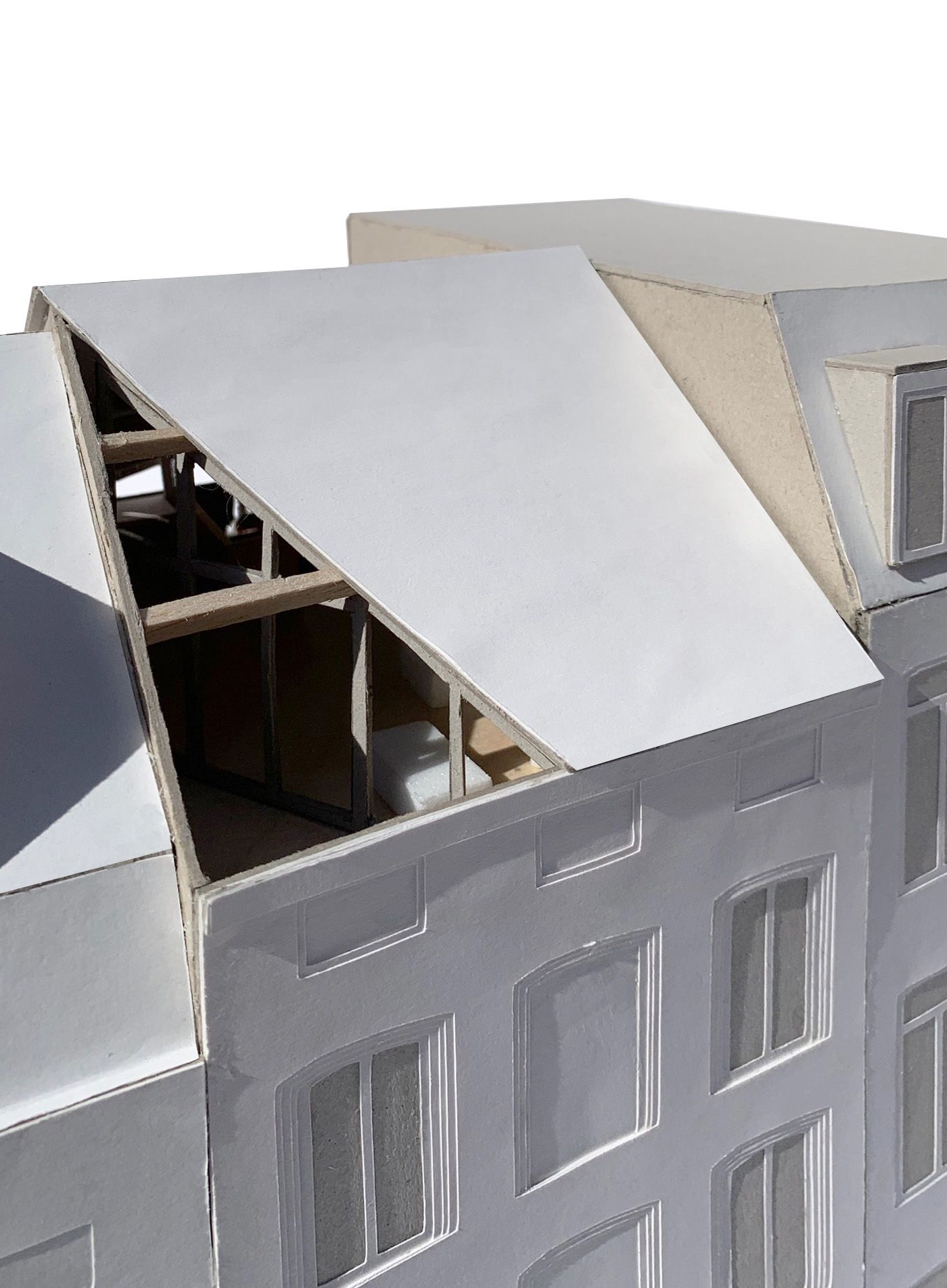 White exterior model with an angular roof cut revealing timber structure