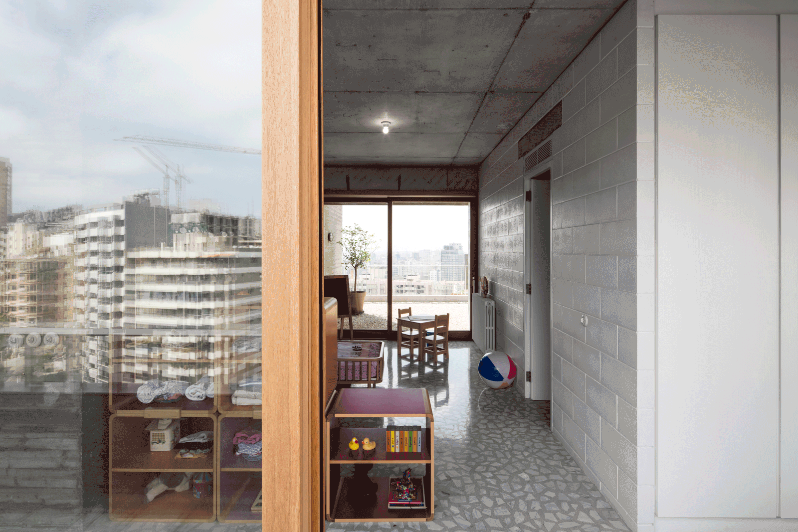 Window bay with timber shelving beside the concrete passage