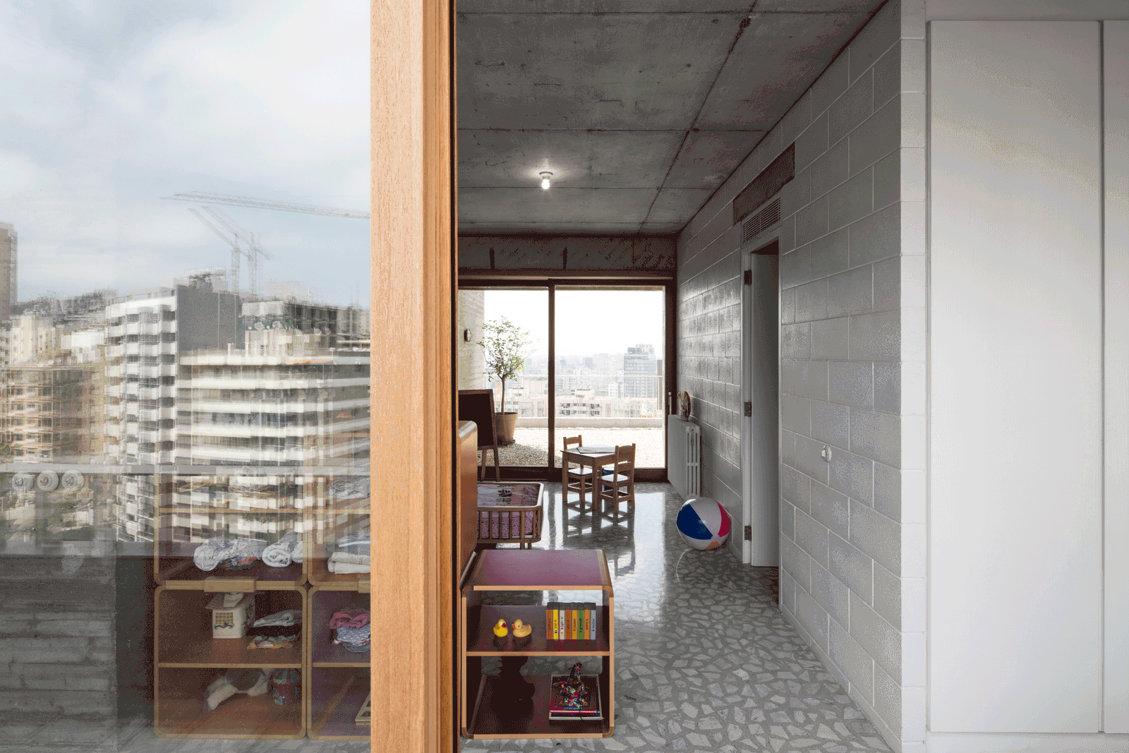 Window bay with timber shelving beside the concrete passage