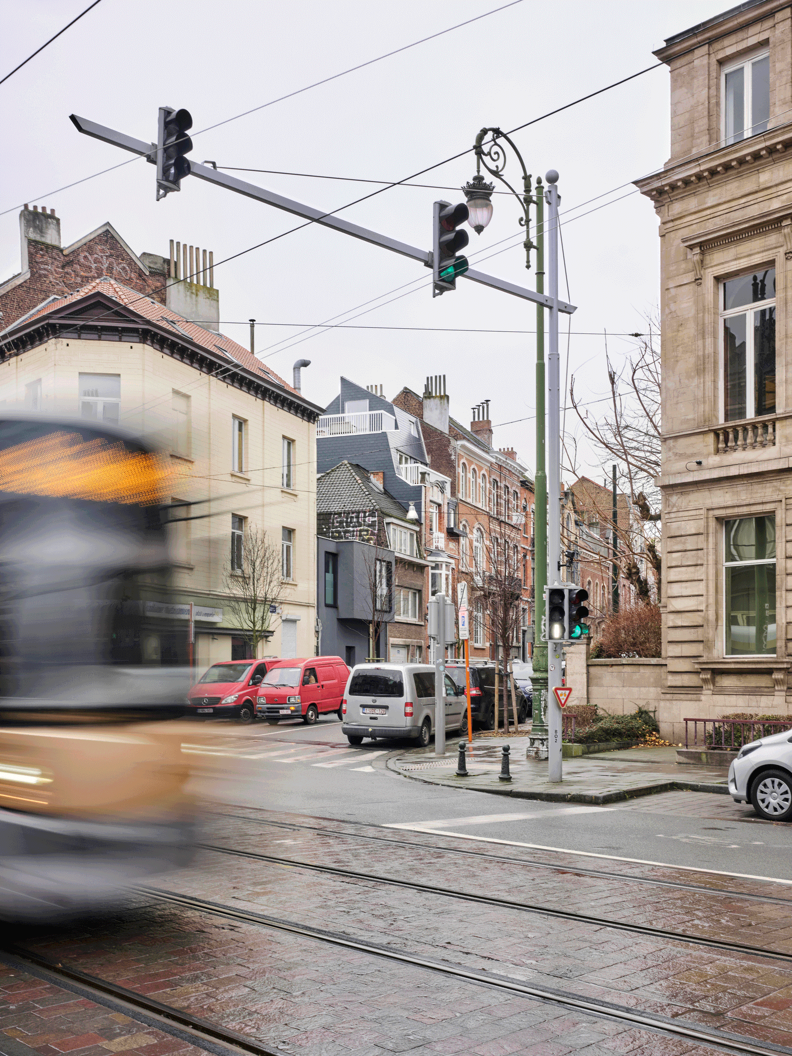 Tram crossing the urban intersection outside the house
