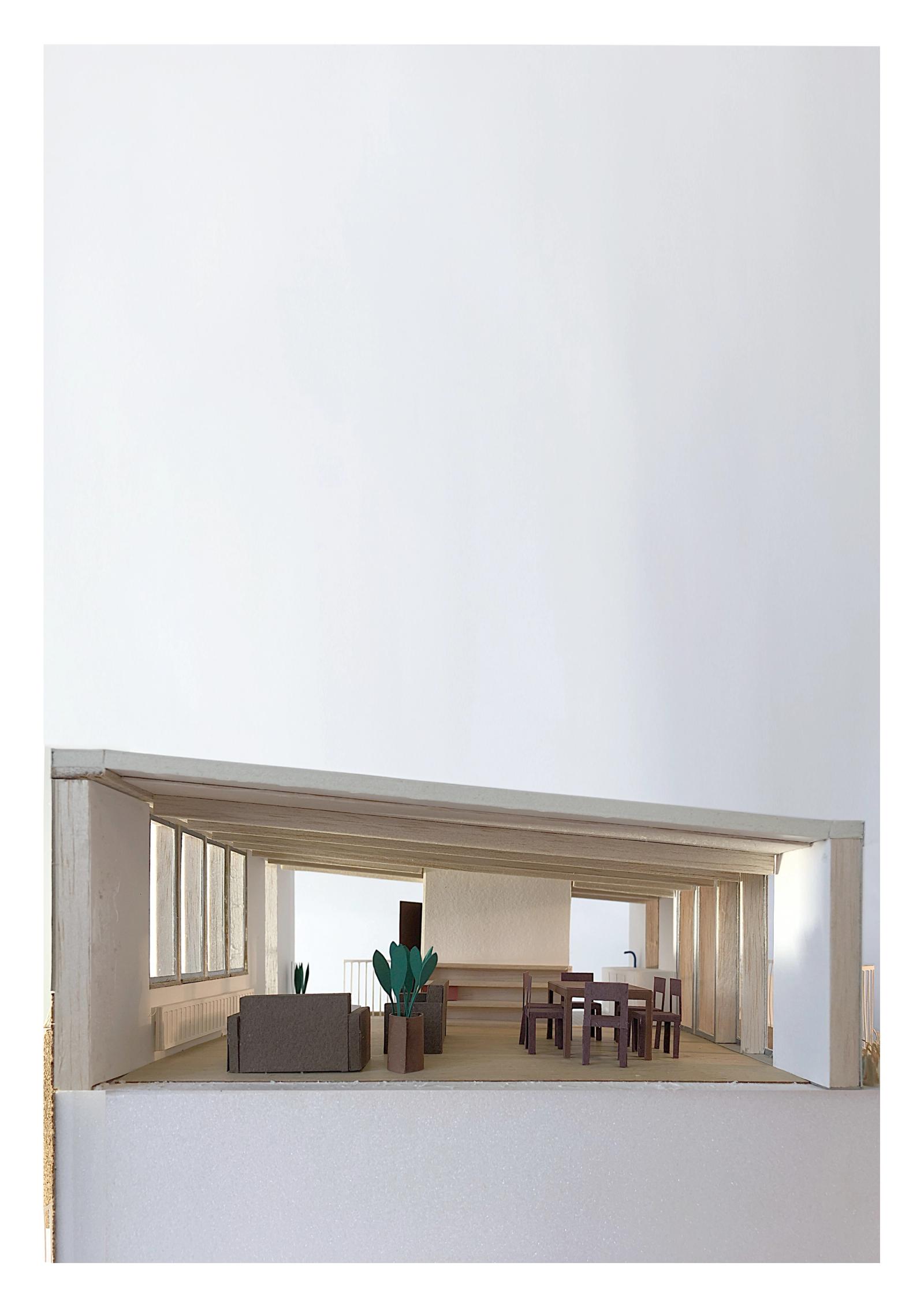 Sectional model of a living room opening to a recessed balcony