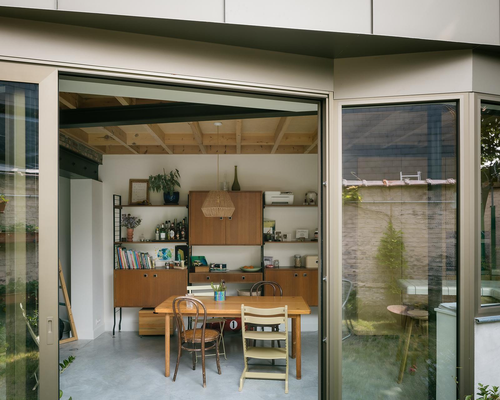 Kitchen and dining room seen through open sliding garden doors