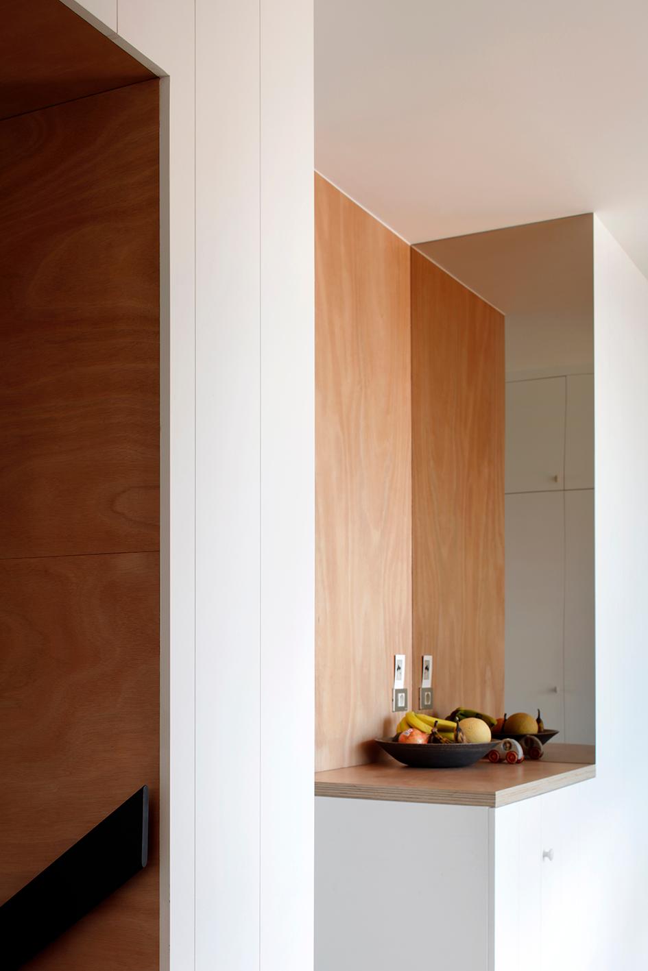 Deep timber-lined niche built into the white interior wall